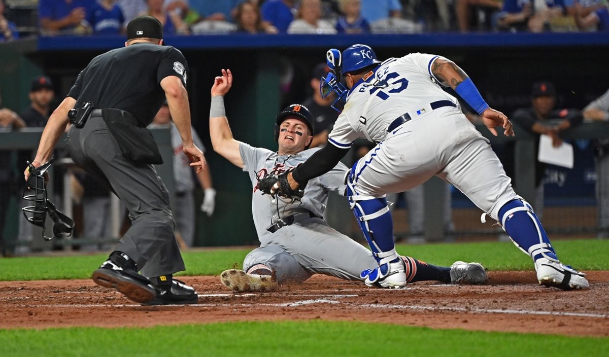 Sep 18, 2024; Kansas City, Missouri, USA;  Detroit Tigers base runner Jace Jung (17) slides past Kansas City Royals catcher Salvador Perez (13) to score a run in the third inning at Kauffman Stadium. Mandatory Credit: Peter Aiken-Imagn Images