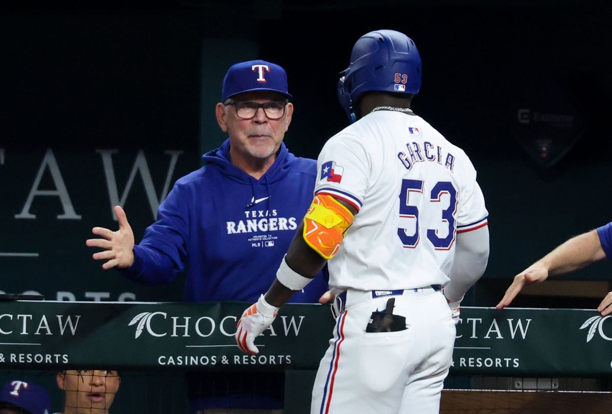 Sep 18, 2024; Arlington, Texas, USA;  Texas Rangers right fielder Adolis Garcia (53) celebrates with Texas Rangers manager Bruce Bochy (15) after hitting a two-run home run during the sixth inning against the Toronto Blue Jays at Globe Life Field. Mandatory Credit: Kevin Jairaj-Imagn Images