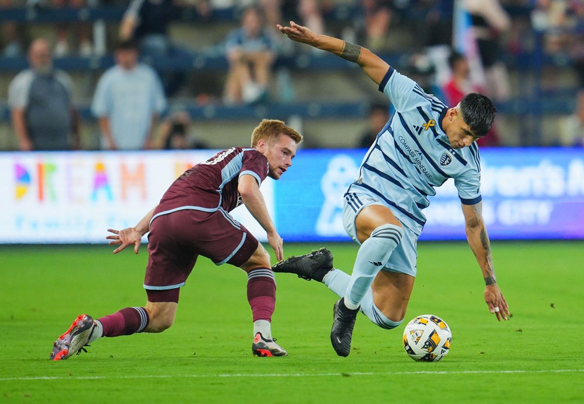 Sep 18, 2024; Kansas City, Kansas, USA; Sporting Kansas City forward Alan Pulido (9) controls the ball against Colorado Rapids midfielder Connor Ronan (20) during the first half at Children's Mercy Park. Mandatory Credit: Jay Biggerstaff-Imagn Images