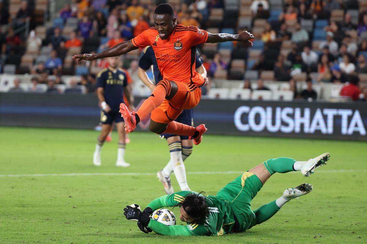 Sep 18, 2024; Houston, Texas, USA; Vancouver Whitecaps FC goalkeeper Yohei Takaoka (1) steals the ball away from Houston Dynamo FC forward Ibrahim Aliyu (18) during the first half at Shell Energy Stadium. Mandatory Credit: Thomas Shea-Imagn Images