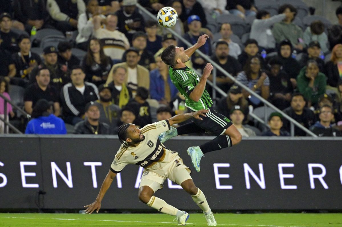 Sep 18, 2024; Los Angeles, California, USA; Austin FC forward Diego Rubio (14) heads the ball against LAFC defender Eddie Segura (4) in the first half at BMO Stadium. Mandatory Credit: Jayne Kamin-Oncea-Imagn Images
