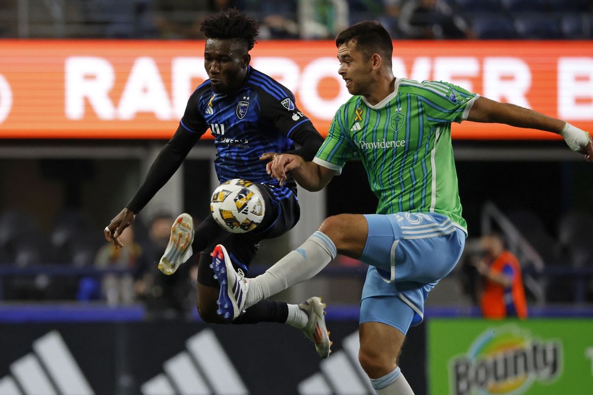 Sep 18, 2024; Seattle, Washington, USA; San Jose Earthquakes forward Ousseni Bouda (17) kicks the ball past Seattle Sounders FC defender Jackson Ragen (25) during the first half at Lumen Field. Mandatory Credit: Joe Nicholson-Imagn Images