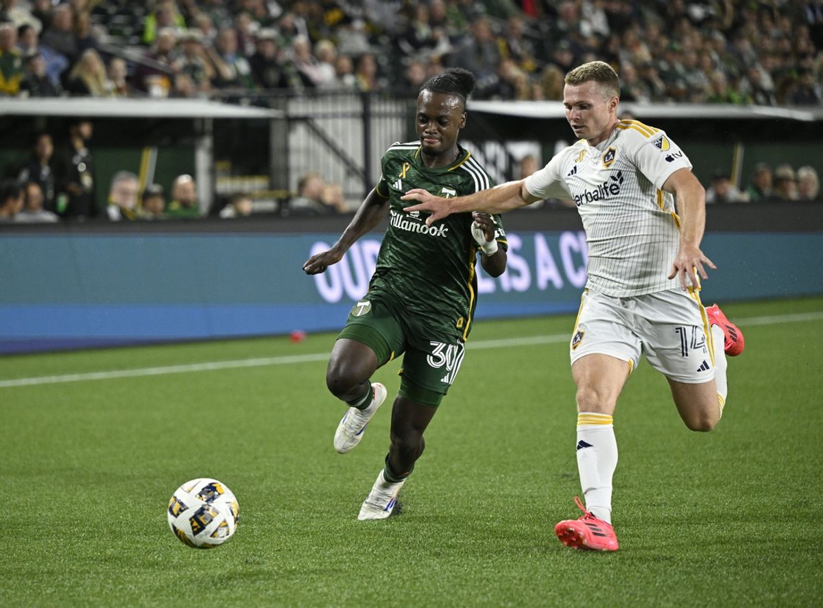 Sep 18, 2024; Portland, Oregon, USA; Portland Timbers forward Santiago Moreno (30) battles LA Galaxy defender John Nelson (14) for control of a ball during the second half at Providence Park. Mandatory Credit: Troy Wayrynen-Imagn Images