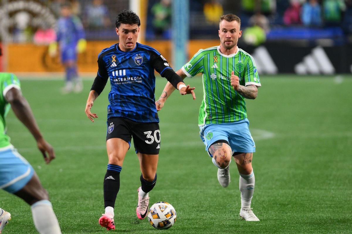 Sep 18, 2024; Seattle, Washington, USA; San Jose Earthquakes midfielder Niko Tsakiris (30) kicks the ball past Seattle Sounders FC midfielder Albert Rusnak (11) during the second half at Lumen Field. Mandatory Credit: Steven Bisig-Imagn Images