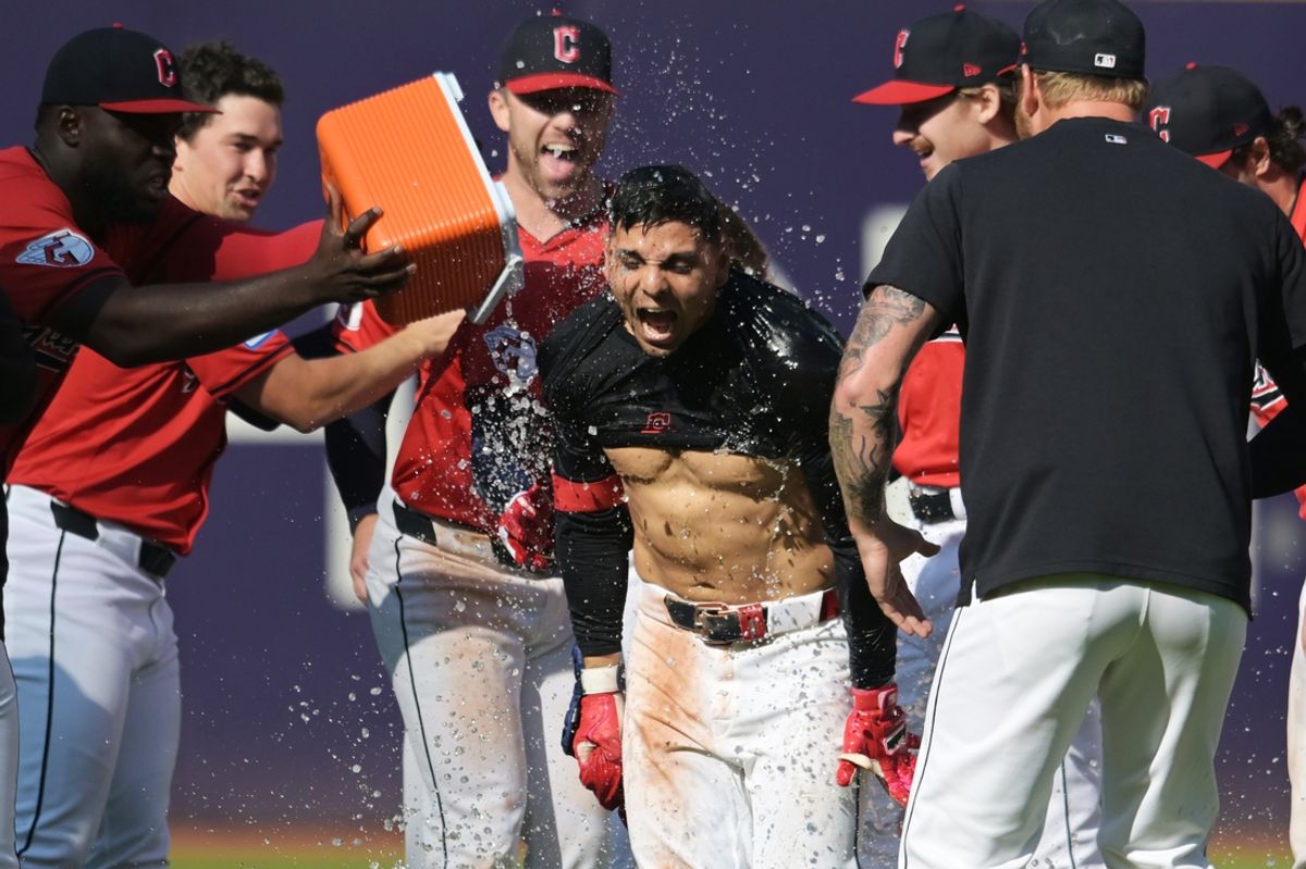 Sep 19, 2024; Cleveland, Ohio, USA; Cleveland Guardians second baseman Andres Gimenez (0) is doused by Cleveland Guardians right fielder Jhonkensy Noel, left, after getting the game-winning hit during the tenth inning against the Minnesota Twins at Progressive Field. With the win the Guardians clinched a playoff berth. Mandatory Credit: Ken Blaze-Imagn Images