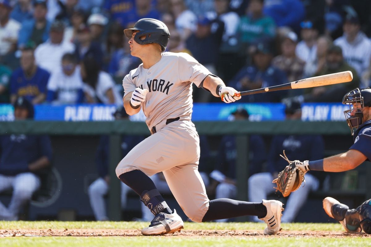Sep 19, 2024; Seattle, Washington, USA; New York Yankees shortstop Anthony Volpe (11) hits a single against the Seattle Mariners during the second inning at T-Mobile Park. Mandatory Credit: Joe Nicholson-Imagn Images