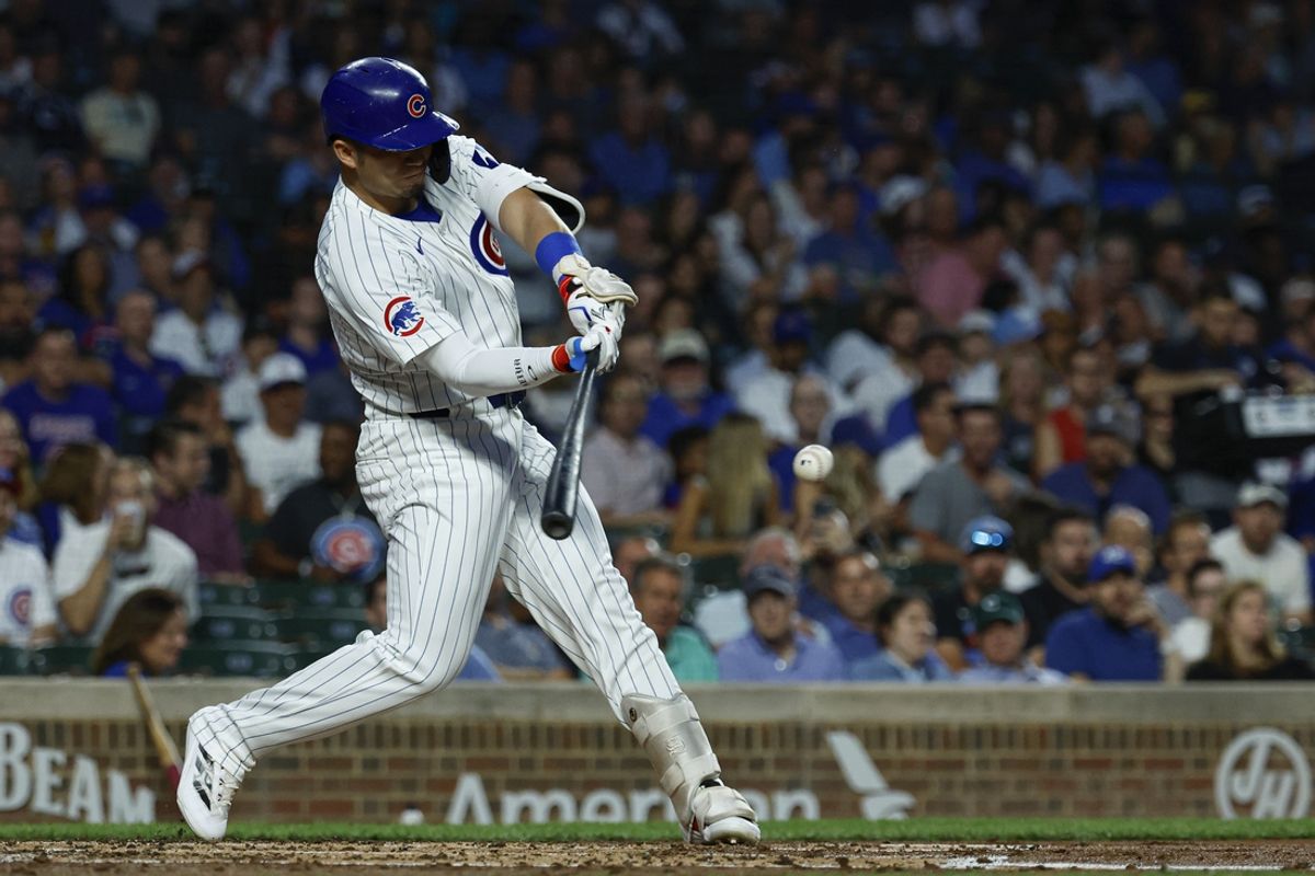 Sep 19, 2024; Chicago, Illinois, USA; Chicago Cubs outfielder Seiya Suzuki (27) singles against the Washington Nationals during the first inning at Wrigley Field. Mandatory Credit: Kamil Krzaczynski-Imagn Images
