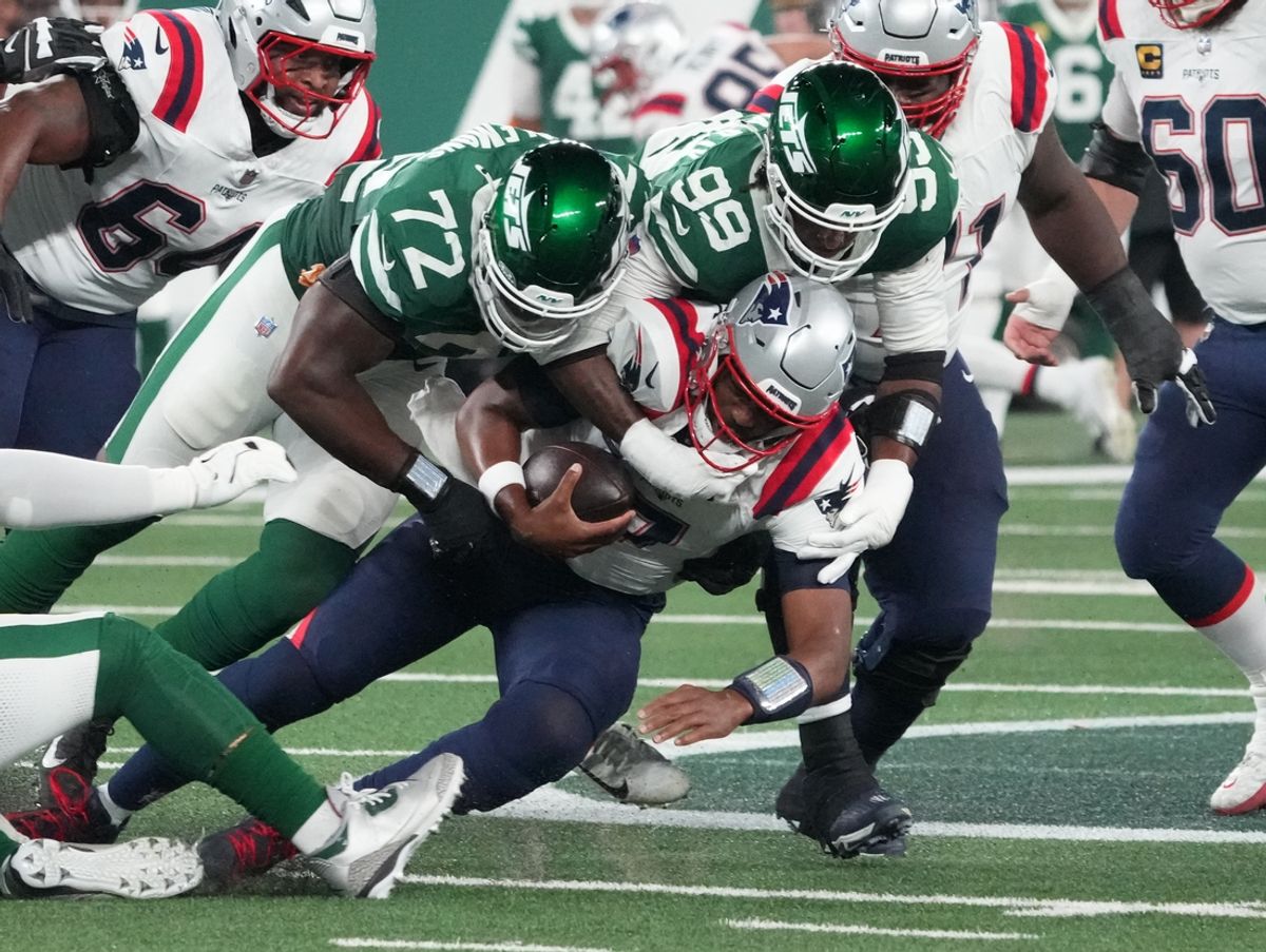 Sep 19, 2024; East Rutherford, New Jersey, USA;  New England Patriots quarterback Jacoby Brissett (7) sacked by New York Jets defensive end Micheal Clemons (72)  and  defensive end Will McDonald IV (99)  in the 1st half at MetLife Stadium. Mandatory Credit: Robert Deutsch-Imagn Images