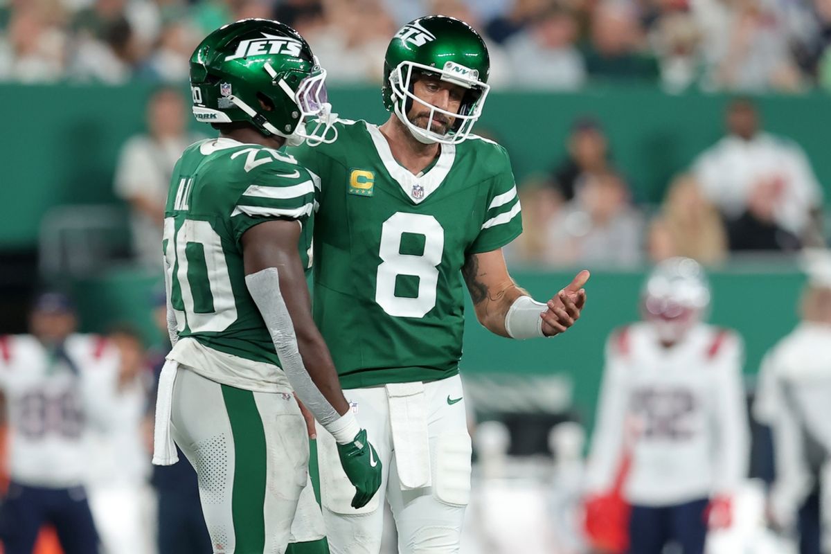 Sep 19, 2024; East Rutherford, New Jersey, USA; New York Jets quarterback Aaron Rodgers (8) reacts as he talks to running back Breece Hall (20) during the third quarter against the New England Patriots at MetLife Stadium. Mandatory Credit: Brad Penner-Imagn Images