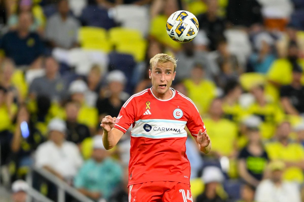 Sep 18, 2024; Nashville, Tennessee, USA;  Chicago Fire defender Wyatt Omsberg (16) heads the ball  against the Nashville SC during the second half at Geodis Park. Mandatory Credit: Steve Roberts-Imagn Images