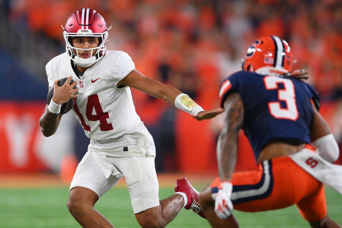 Sep 20, 2024; Syracuse, New York, USA; Stanford Cardinal quarterback Ashton Daniels (14) runs as Syracuse Orange defensive back Clarence Lewis (3) defends during the first half at the JMA Wireless Dome. Mandatory Credit: Rich Barnes-Imagn Images