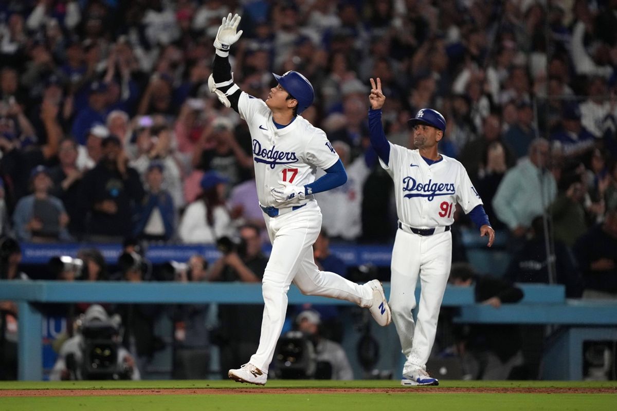 Sep 20, 2024; Los Angeles, California, USA; Los Angeles Dodgers designated hitter Shohei Ohtani (17) celebrates with third base coach Dino Ebel (91) after hitting a two-run home run in the fifth inning against the Colorado Rockies at Dodger Stadium. Mandatory Credit: Kirby Lee-Imagn Images