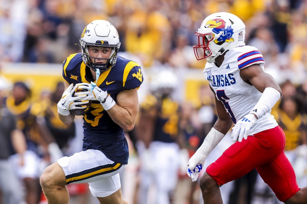 Sep 21, 2024; Morgantown, West Virginia, USA; West Virginia Mountaineers wide receiver Hudson Clement (3) catches a pass and runs for extra yards during the first quarter against the Kansas Jayhawks at Mountaineer Field at Milan Puskar Stadium. Mandatory Credit: Ben Queen-Imagn Images