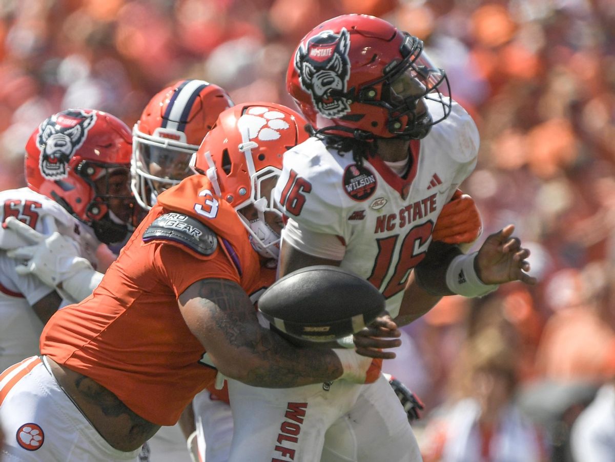Sep 21, 2024; Clemson, South Carolina, USA; Clemson Tigersdefensive end T.J. Parker (3) hits North Carolina State Wolfpack quarterback CJ Bailey (16) to force a fumble during the first quarter at Memorial Stadium. Mandatory Credit: Ken Ruinard-Imagn Images