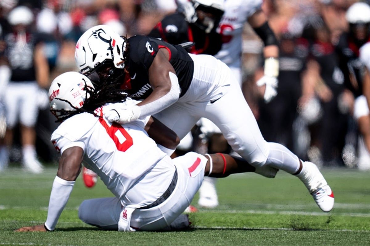 Cincinnati Bearcats defensive lineman Marquaze Parker (98) tackles Houston Cougars wide receiver Devan Williams (8) in the second quarter of the College Football game at Nippert Stadium in Cincinnati on Saturday, Sept. 21, 2024.