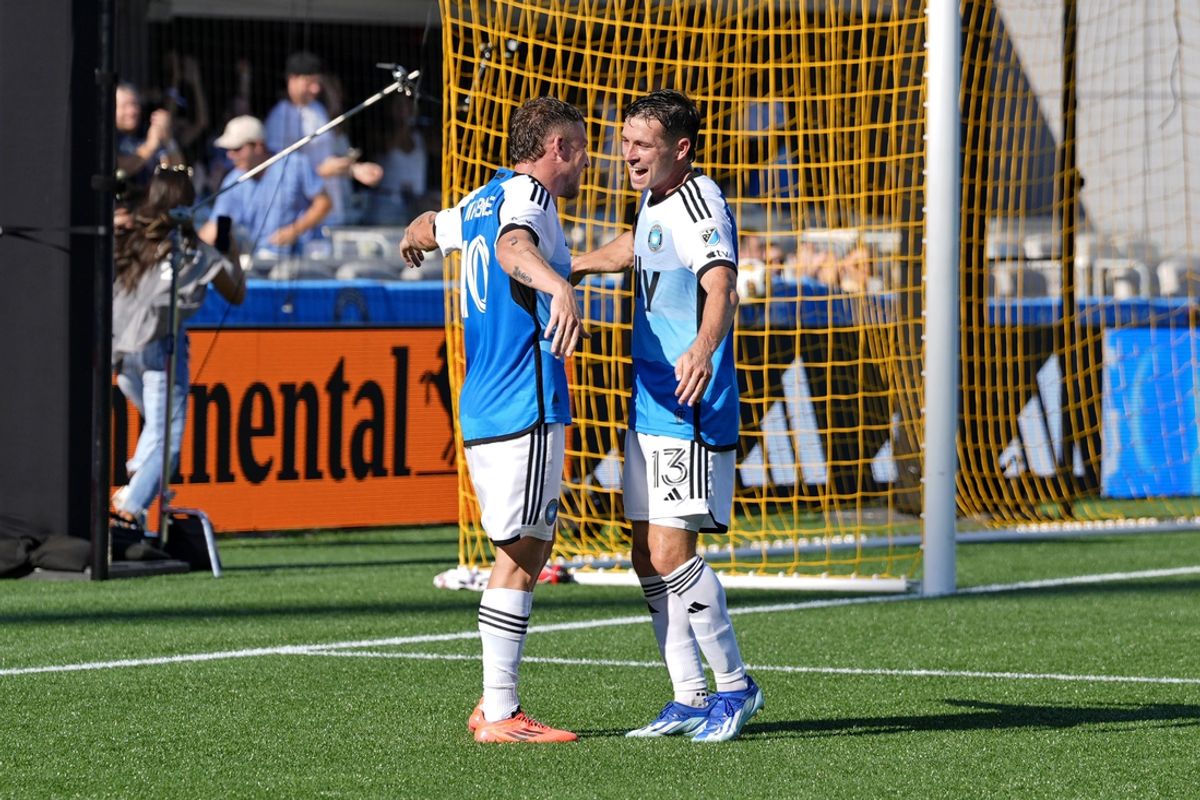Sep 21, 2024; Charlotte, North Carolina, USA; Charlotte FC midfielder Brandt Bronico (13) and midfielder Pep Biel (10) celebrate after forward Liel Abada (not pictured) scored a goal against the New England Revolution during the first half at Bank of America Stadium. Mandatory Credit: Jim Dedmon-Imagn Images