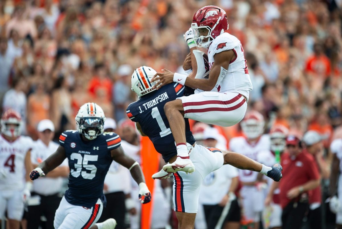 Arkansas Razorbacks quarterback Taylen Green (10) fails to hurdle over Auburn Tigers defensive back Jerrin Thompson (1) as Auburn Tigers take on Arkansas Razorbacks at Jordan-Hare Stadium in Auburn, Ala., on Saturday, Sept. 21, 2024. Arkansas Razorbacks lead Auburn Tigers 7-0 at halftime.