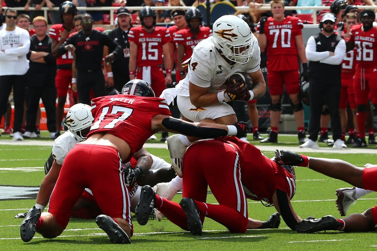 Sep 21, 2024; Lubbock, Texas, USA;  Arizona State Sun Devils running back Cam Skattebo (4) runs the ball against Texas Tech Red Raiders defensive back Isaac Smith (17) in the first half at Jones AT&T Stadium and Cody Campbell Field. Mandatory Credit: Michael C. Johnson-Imagn Images