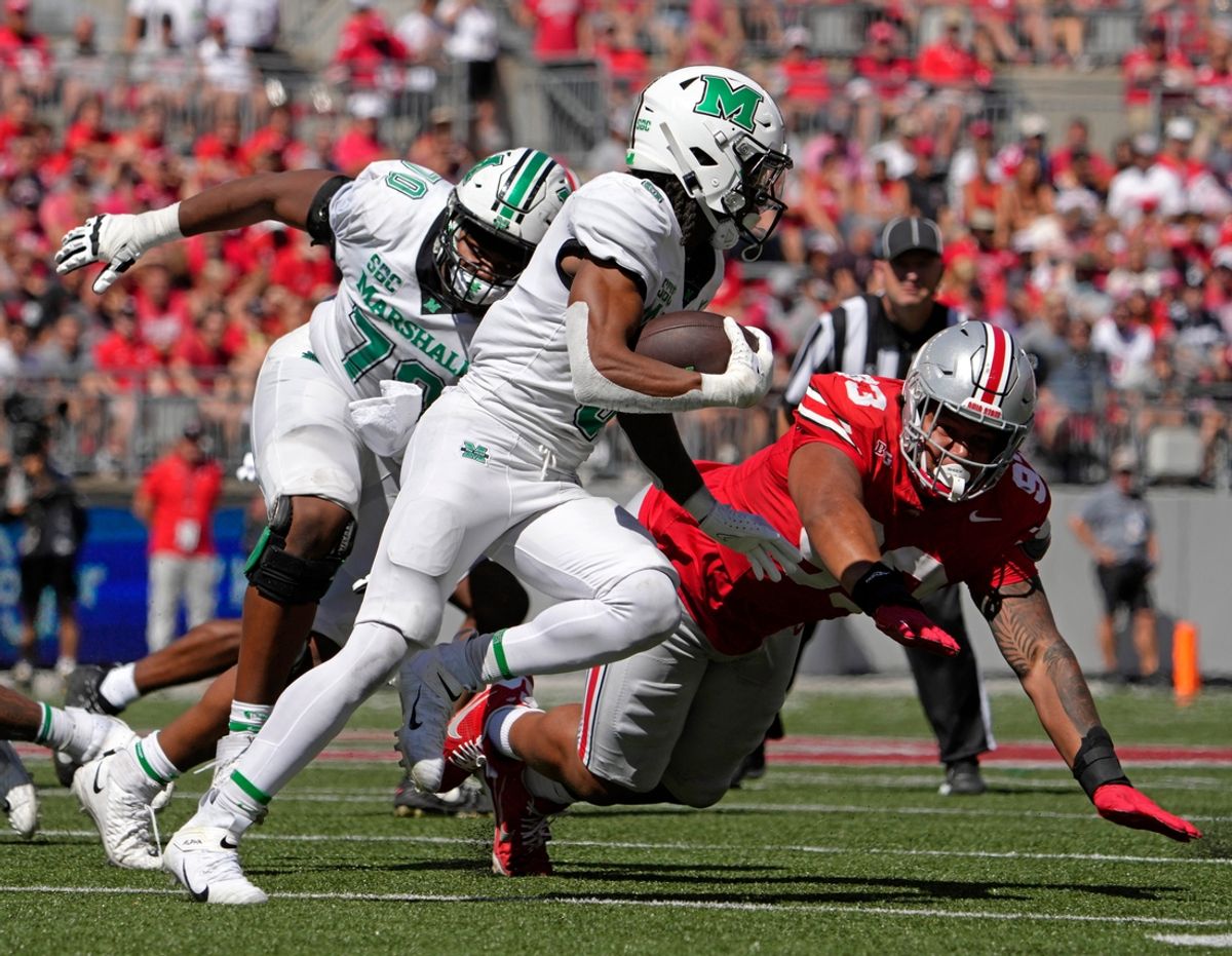 Sept. 21, 2024; Columbus, Ohio, USA;
Marshall Thundering Herd running back A.J. Turner (5) is pursued by Ohio State Buckeyes defensive tackle Hero Kanu (93) during the first half of an NCAA Division I football game at Ohio Stadium on Saturday.