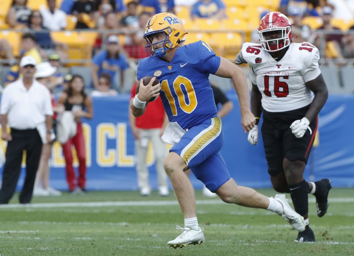 Sep 21, 2024; Pittsburgh, Pennsylvania, USA;  Pittsburgh Panthers quarterback Eli Holstein (10) runs with the ball against Youngstown State Penguins defensive lineman Jabarrek Hopkins (16)  during the third quarter at Acrisure Stadium. Mandatory Credit: Charles LeClaire-Imagn Images