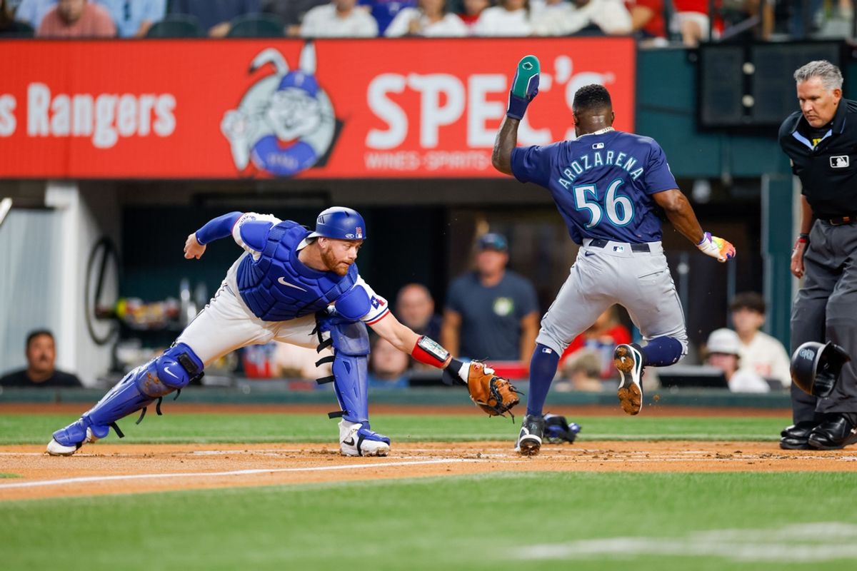 Sep 21, 2024; Arlington, Texas, USA; Texas Rangers catcher Carson Kelly (18) misses a tag of Seattle Mariners outfielder Randy Arozarena (56) during the first inning at Globe Life Field. Mandatory Credit: Andrew Dieb-Imagn Images