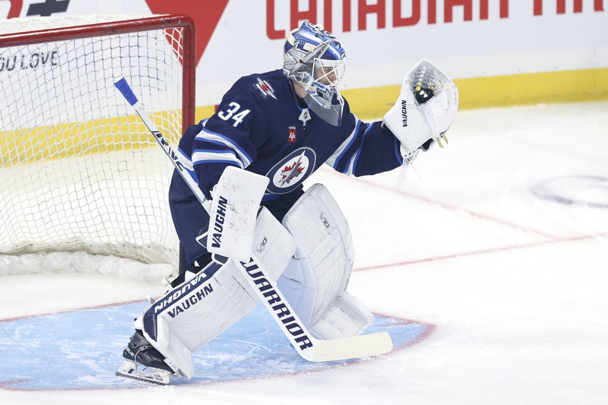 Sep 21, 2024; Winnipeg, Manitoba, CAN;  Winnipeg Jets goaltender Kaapo Kahkonen (34) warms up before a preseason game against the Minnesota Wild at Canada Life Centre. Mandatory Credit: James Carey Lauder-Imagn Images
