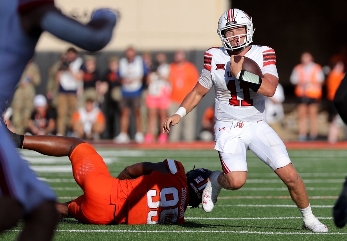 Utah's Isaac Wilson (11) gets by Oklahoma State's Iman Oates (99) in the second half of the college football between the Oklahoma State University Cowboys and the Utah Utes at Boone Pickens Stadium in Stillwater, Okla., Saturday, Sept., 21, 2024.