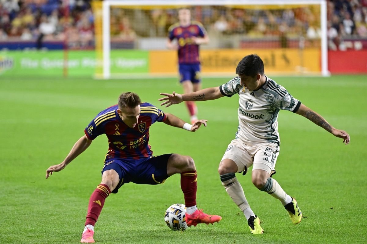 Sep 21, 2024; Sandy, Utah, USA; Real Salt Lake midfielder Andres Gomez (11) battles Portland Timbers defender Claudio Bravo (5) for the ball in the first half at America First Field. Mandatory Credit: Peter Creveling-Imagn Images