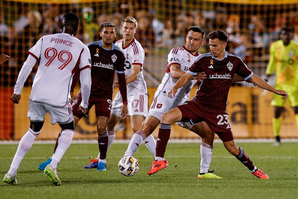 Sep 21, 2024; Commerce City, Colorado, USA; Toronto FC defender Shane O'Neill (27) and Colorado Rapids midfielder Cole Bassett (23) battle for the ball as forward Prince Owusu (99) and forward Rafael Navarro (9) and defender Sigurd Rosted (17) look on in the first half at Dick's Sporting Goods Park. Mandatory Credit: Isaiah J. Downing-Imagn Images