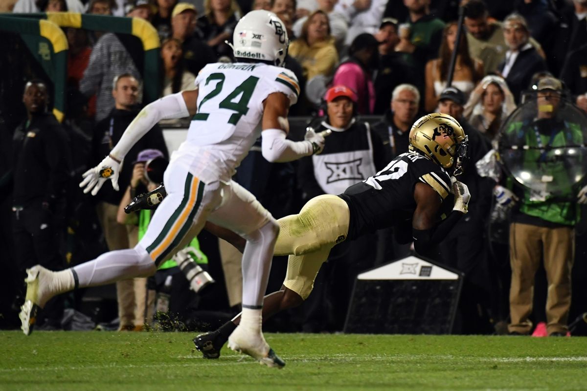 Sep 21, 2024; Boulder, Colorado, USA; Colorado Buffaloes wide receiver Travis Hunter (12) dives as he catches a pass during the second half against the Baylor Bears at Folsom Field. Mandatory Credit: Christopher Hanewinckel-Imagn Images