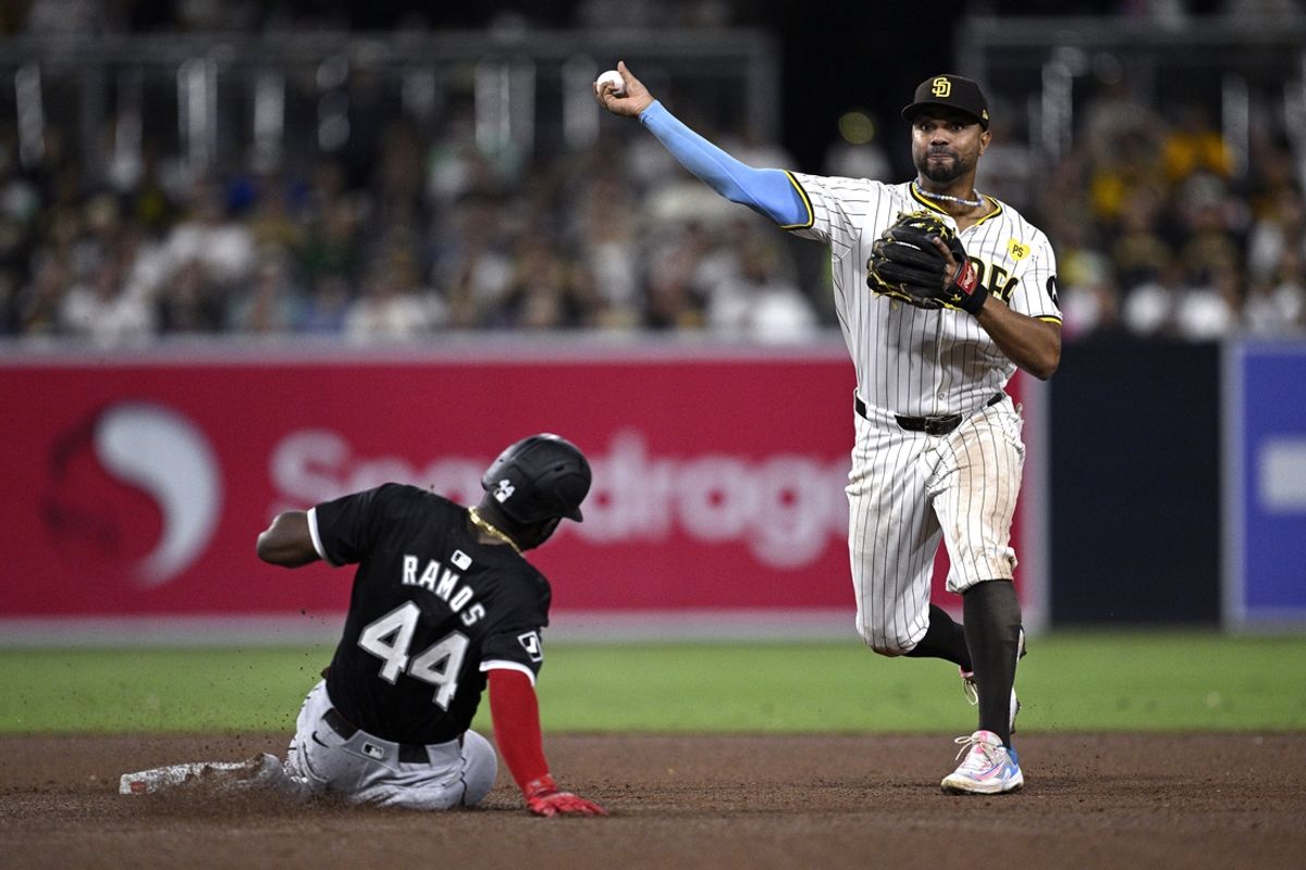 Sep 21, 2024; San Diego, California, USA; San Diego Padres shortstop Xander Bogaerts (right) throws to first base after forcing out Chicago White Sox designated hitter Bryan Ramos (44) at second base to complete a double play to end the top of the eighth inning at Petco Park. Mandatory Credit: Orlando Ramirez-Imagn Images