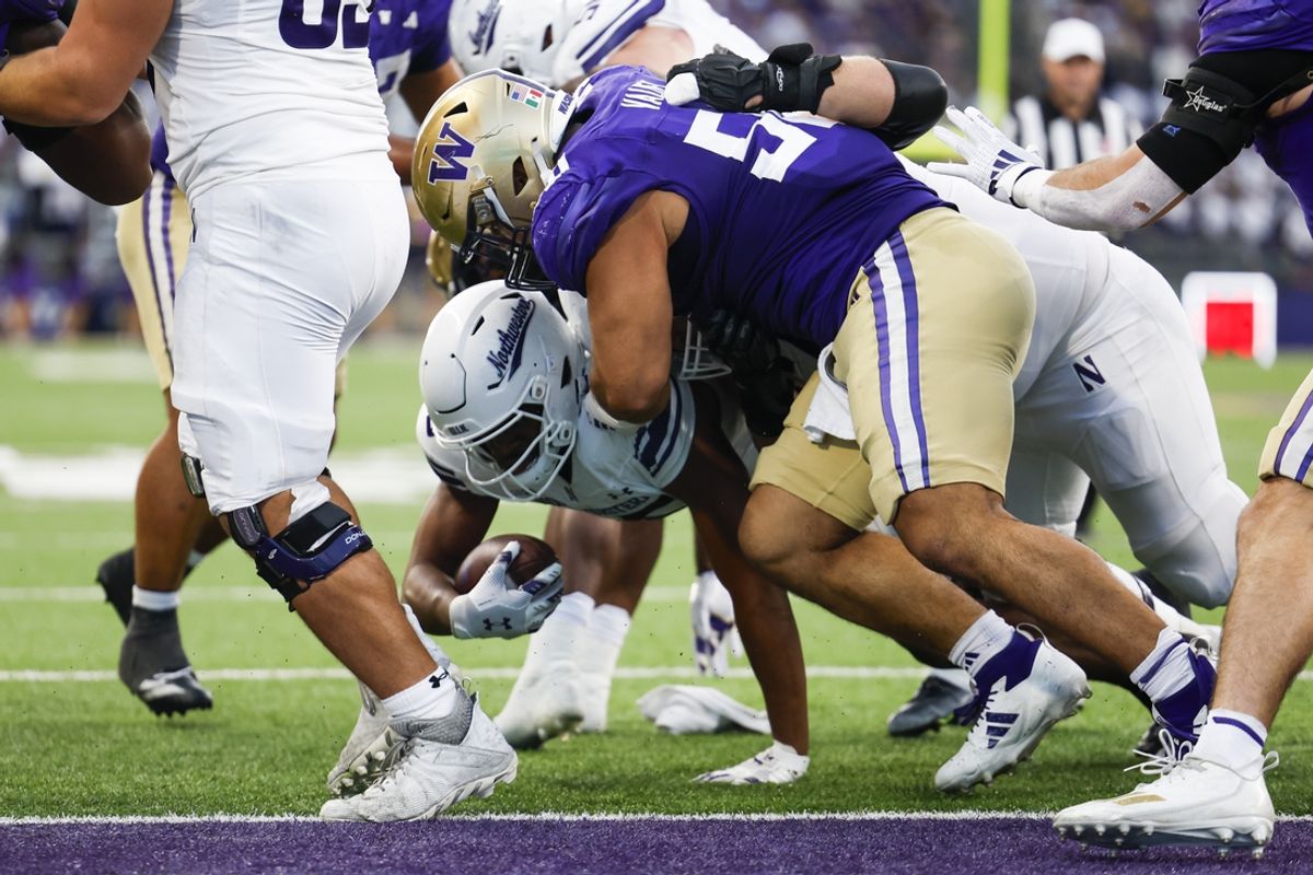 Sep 21, 2024; Seattle, Washington, USA; Washington Huskies defensive tackle Sebastian Valdez (50) tackles Northwestern Wildcats running back Caleb Komolafe (25) short of the end zone during the fourth quarter at Alaska Airlines Field at Husky Stadium. Mandatory Credit: Joe Nicholson-Imagn Images