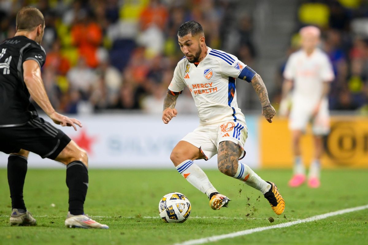 Sep 21, 2024; Nashville, Tennessee, USA;  FC Cincinnati midfielder Luciano Acosta (10) dribbles the ball against the Nashville SC during the second half at Geodis Park. Mandatory Credit: Steve Roberts-Imagn Images