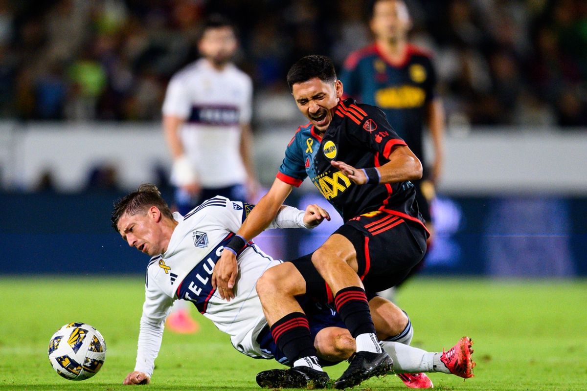 Sep 21, 2024; Carson, California, USA; Vancouver Whitecaps FC midfielder Ryan Gauld (25) and LA Galaxy midfielder Marco Delgado (8) battle for the ballduring the second half at Dignity Health Sports Park. Mandatory Credit: Kelvin Kuo-Imagn Images