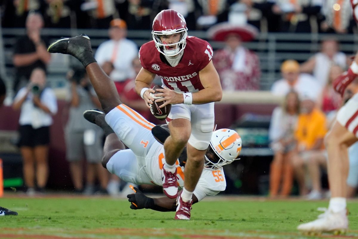 Oklahoma Sooners quarterback Jackson Arnold (11) runs past Tennessee Volunteers defensive lineman Omarr Norman-Lott (55) during a college football game between the University of Oklahoma Sooners (OU) and the Tennessee Volunteers at Gaylord Family - Oklahoma Memorial Stadium in Norman, Okla., Saturday, Sept. 21, 2024.