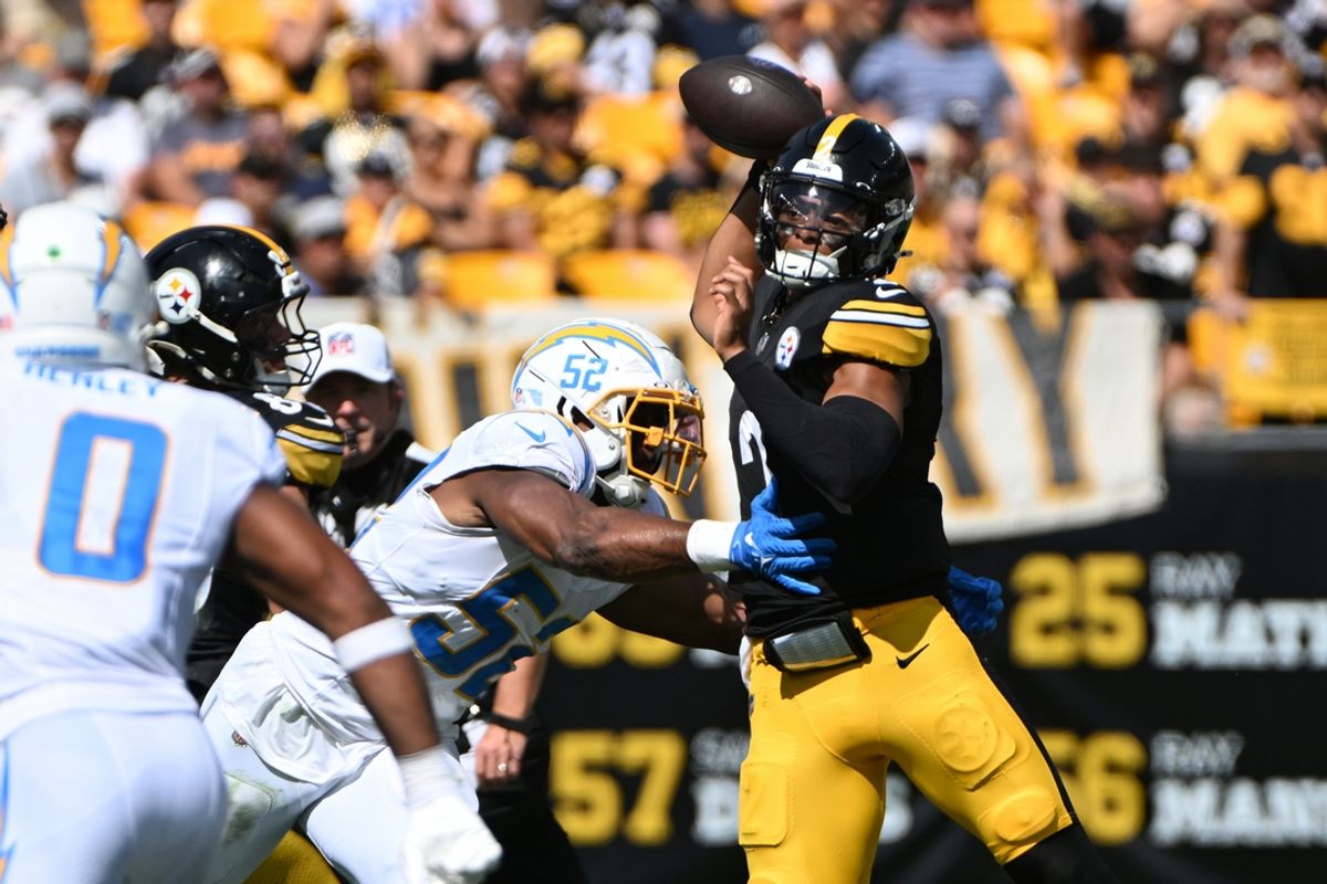 Sep 22, 2024; Pittsburgh, Pennsylvania, USA; Pittsburgh Steelers quarterback Justin Fields (2) throws a pass while under pressure from Los Angeles Chargers linebacker Khalil Mack (52) during the second quarter at Acrisure Stadium. Mandatory Credit: Barry Reeger-Imagn Images