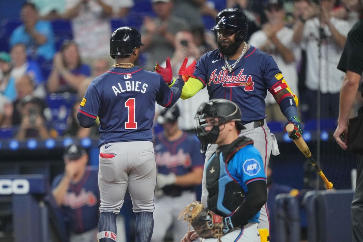 Sep 22, 2024; Miami, Florida, USA;  Atlanta Braves second baseman Ozzie Albies (1) is congratulated by designated hitter Marcell Ozuna (20) after hitting a solo home run against the Miami Marlins in the first inning at loanDepot Park. Mandatory Credit: Jim Rassol-Imagn Images