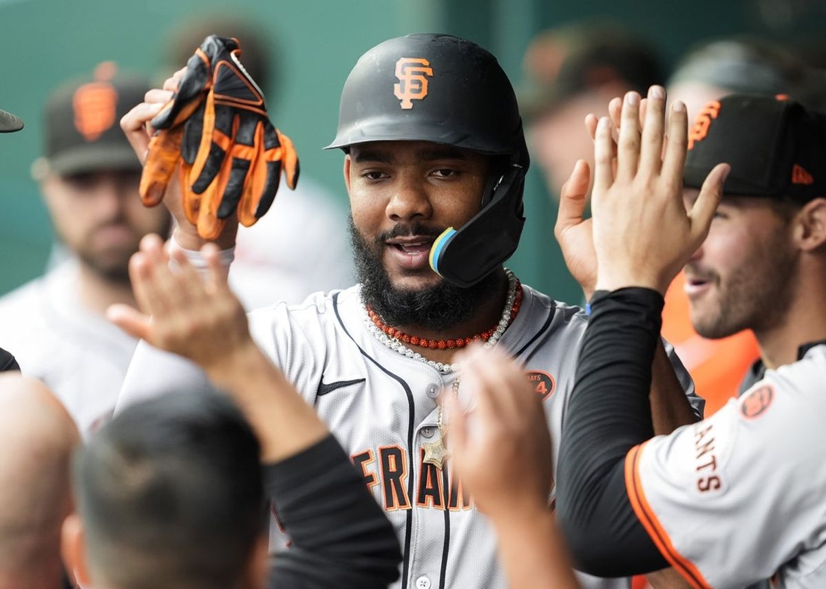 Sep 22, 2024; Kansas City, Missouri, USA; San Francisco Giants right fielder Jerar Encarnacion (59) is congratulated by teammates after scoring during the second inning against the Kansas City Royals at Kauffman Stadium. Mandatory Credit: Jay Biggerstaff-Imagn Images