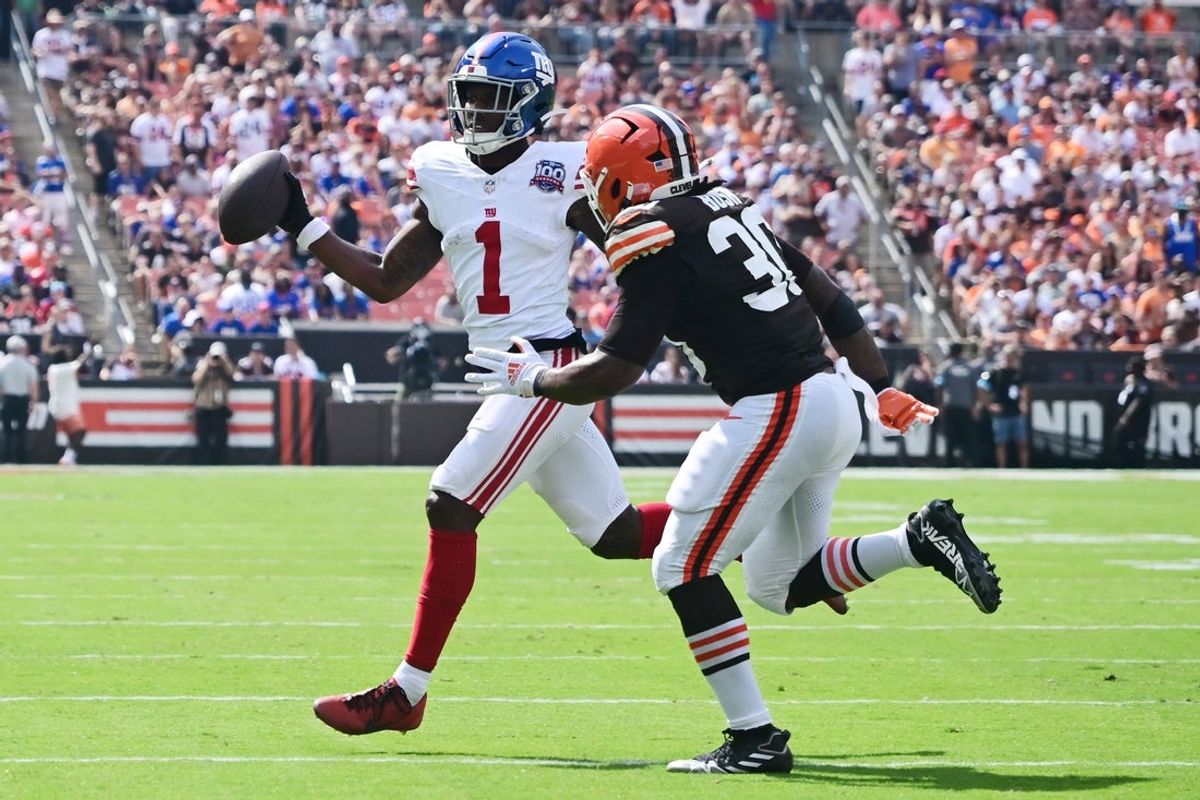 Giants wide receiver Malik Nabers (1) looks to make a pass as Cleveland Browns linebacker Devin Bush (30) defends during the first half at Huntington Bank Field. Mandatory Credit: Ken Blaze-Imagn Images
