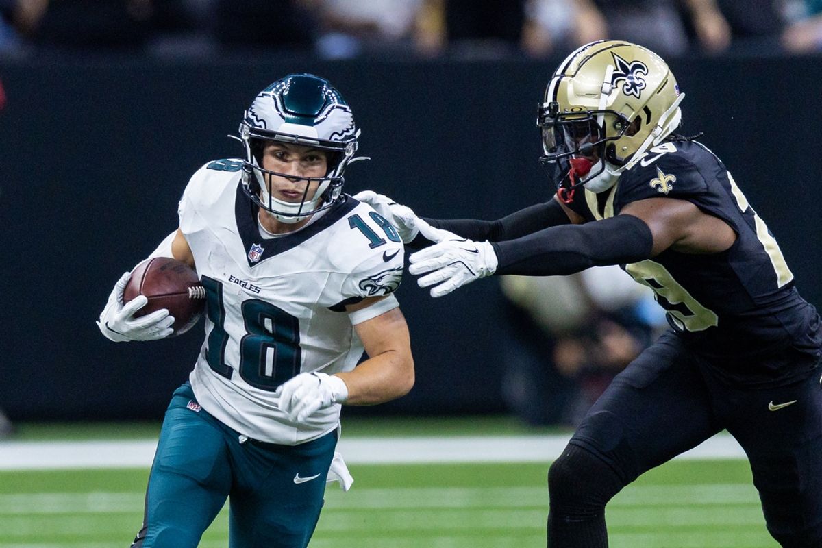 Sep 22, 2024; New Orleans, Louisiana, USA; Philadelphia Eagles wide receiver Britain Covey (18) runs a pass back against New Orleans Saints cornerback Paulson Adebo (29) during the first half at Caesars Superdome. Mandatory Credit: Stephen Lew-Imagn Images