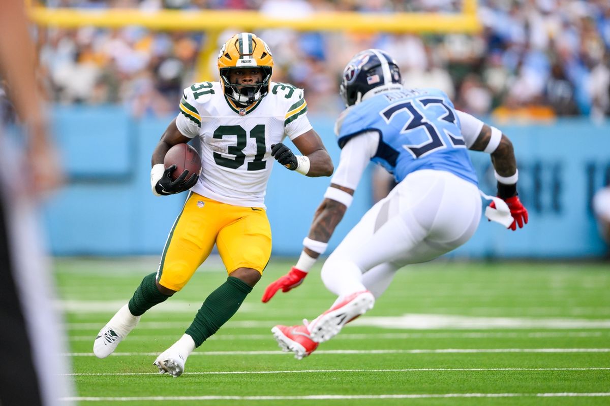 Sep 22, 2024; Nashville, Tennessee, USA;  Tennessee Titans safety Jamal Adams (33) tackles Green Bay Packers running back Emanuel Wilson (31) during the first half at Nissan Stadium. Mandatory Credit: Steve Roberts-Imagn Images