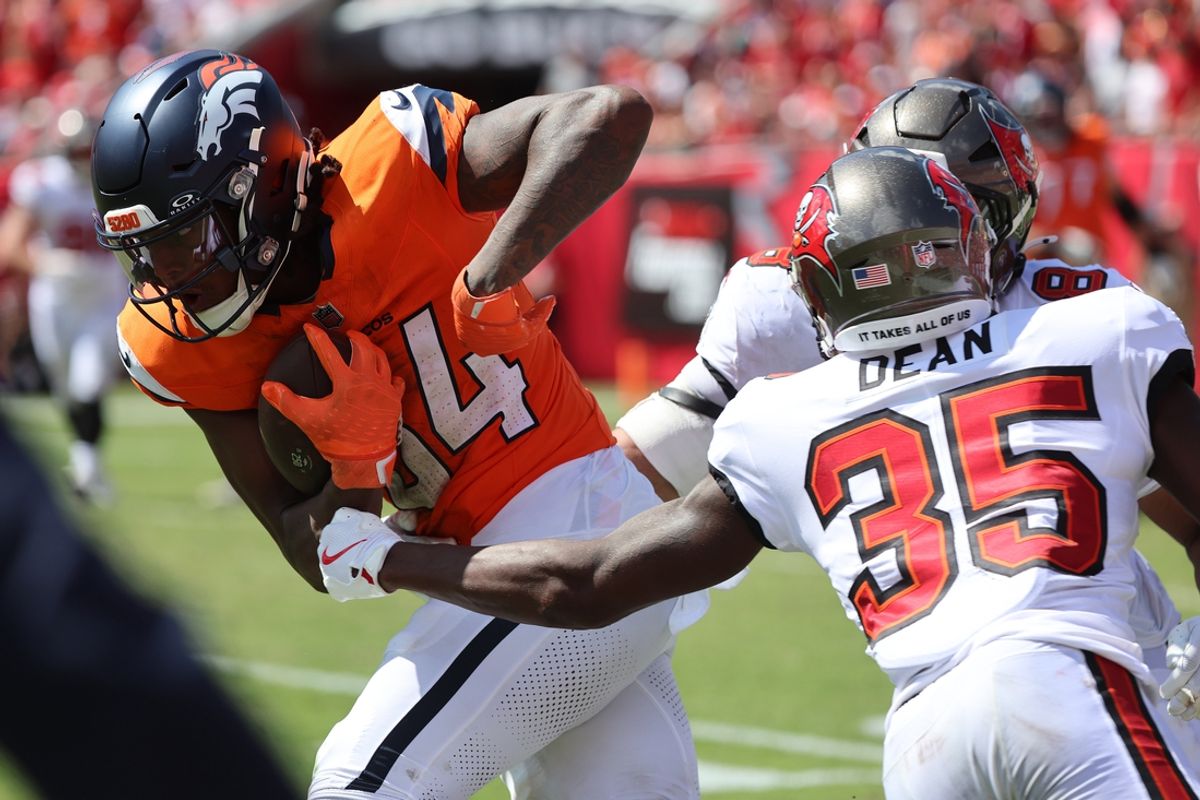 Sep 22, 2024; Tampa, Florida, USA; Denver Broncos wide receiver Lil'Jordan Humphrey (84) runs with the ball as Tampa Bay Buccaneers cornerback Jamel Dean (35) defends during the second half at Raymond James Stadium. Mandatory Credit: Kim Klement Neitzel-Imagn Images