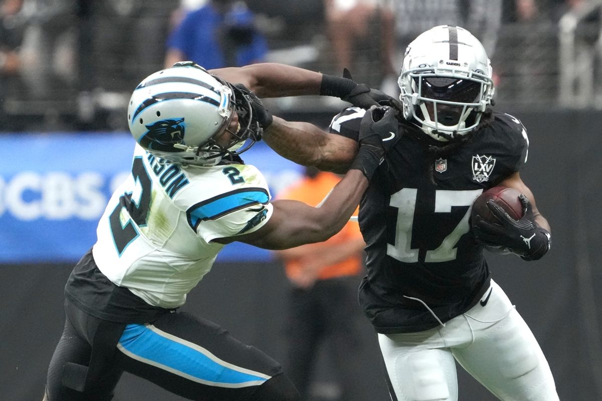 Sep 22, 2024; Paradise, Nevada, USA; Las Vegas Raiders wide receiver Davante Adams (17) carries the ball against Carolina Panthers cornerback Michael Jackson (2) in the first half at Allegiant Stadium. Mandatory Credit: Kirby Lee-Imagn Images