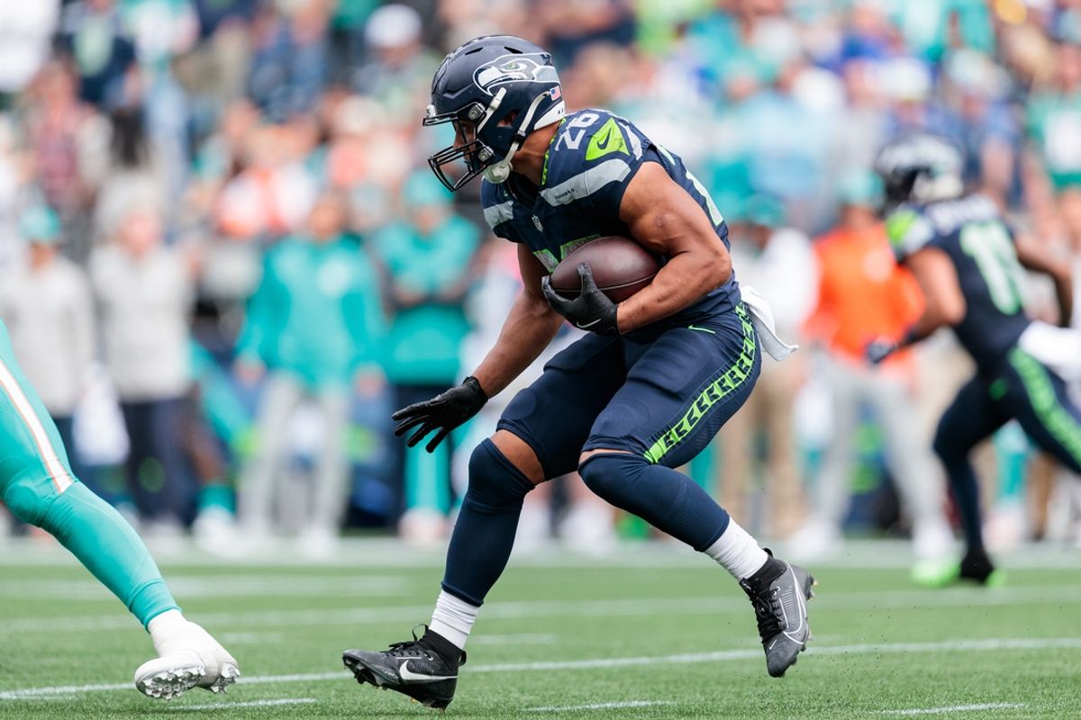 Sep 22, 2024; Seattle, Washington, USA; Seattle Seahawks running back Zach Charbonnet (26) runs with the ball during the second quarter against Miami Dolphins at Lumen Field. Mandatory Credit: Kevin Ng-Imagn Images