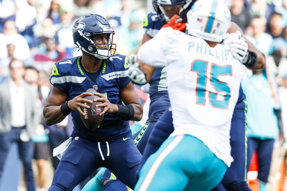 Sep 22, 2024; Seattle, Washington, USA; Seattle Seahawks quarterback Geno Smith (7) looks to pass against the Miami Dolphins during the fourth quarter at Lumen Field. Mandatory Credit: Joe Nicholson-Imagn Images