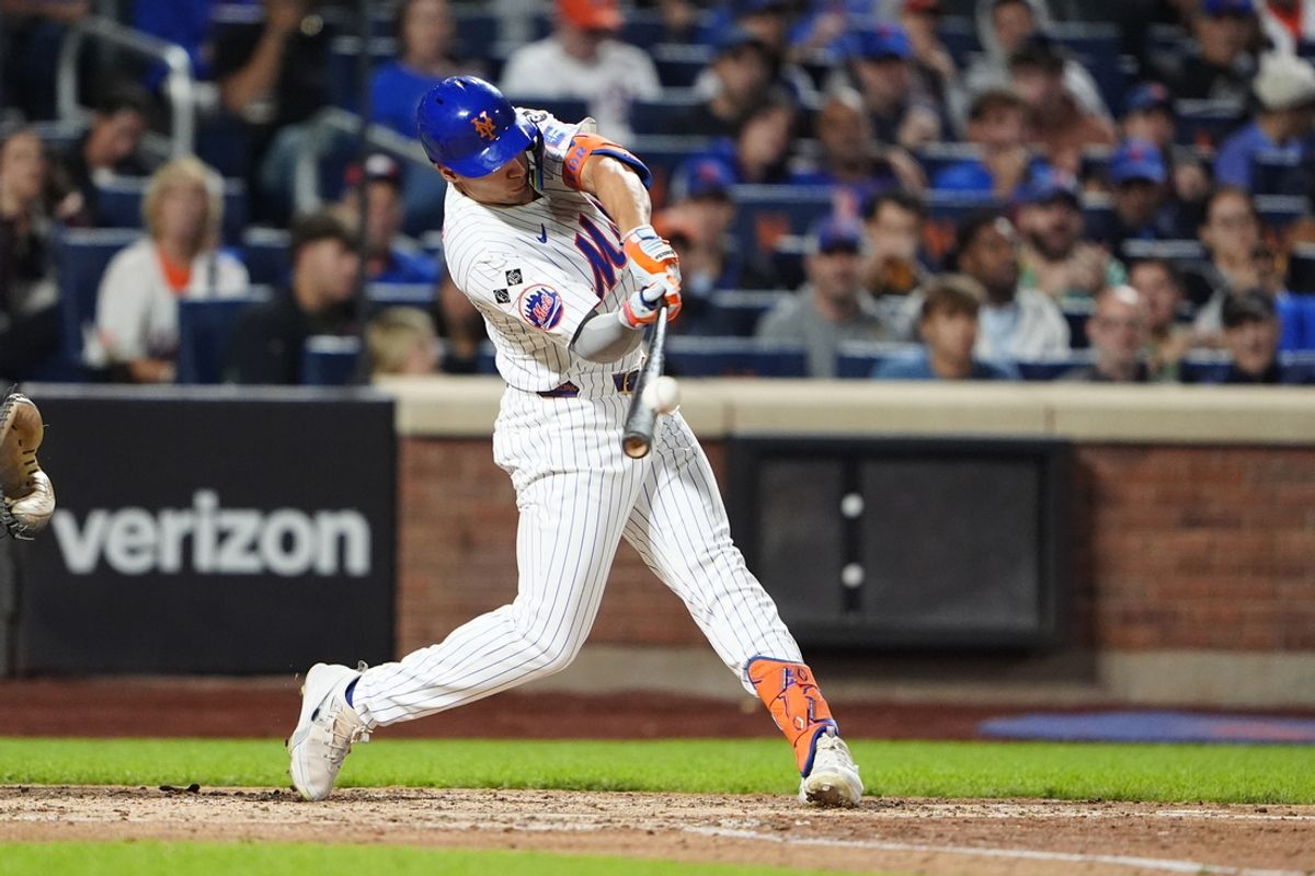 Sep 22, 2024; New York City, New York, USA; New York Mets center fielder Tyrone Taylor (15) hits a single against the Philadelphia Phillies during the fifth inning at Citi Field. Mandatory Credit: Gregory Fisher-Imagn Images