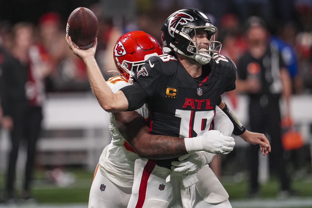 Sep 22, 2024; Atlanta, Georgia, USA; Atlanta Falcons quarterback Kirk Cousins (18) is hit by Kansas City Chiefs defensive end Felix Anudike-Uzomah (97) and fumbles the ball during the first half at Mercedes-Benz Stadium. Mandatory Credit: Dale Zanine-Imagn Images