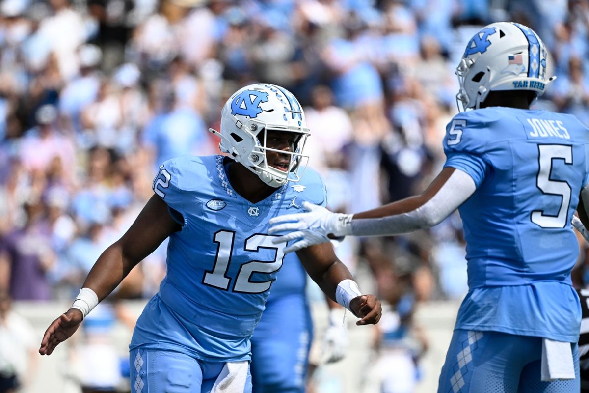 Sep 21, 2024; Chapel Hill, North Carolina, USA; North Carolina Tar Heels quarterback Jacolby Criswell (12) reacts with wide receiver J.J. Jones (5) in the first quarter at Kenan Memorial Stadium. Mandatory Credit: Bob Donnan-Imagn Images