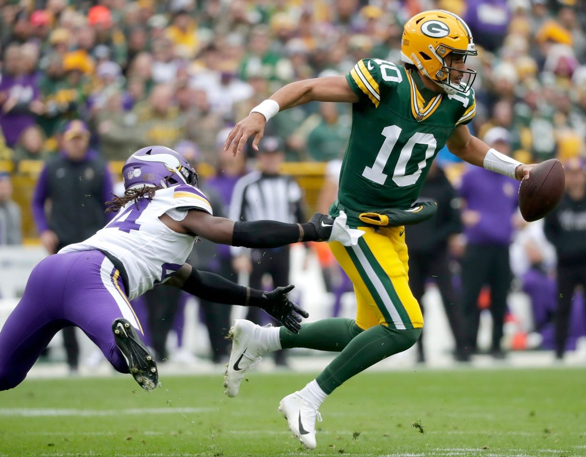 Green Bay Packers quarterback Jordan Love (10) is chased by Minnesota Vikings safety Josh Metellus (44) during their football game Sunday, October 29, 2023, at Lambeau Field in Green Bay, Wis. Minnesota defeated Green Bay 24-10.