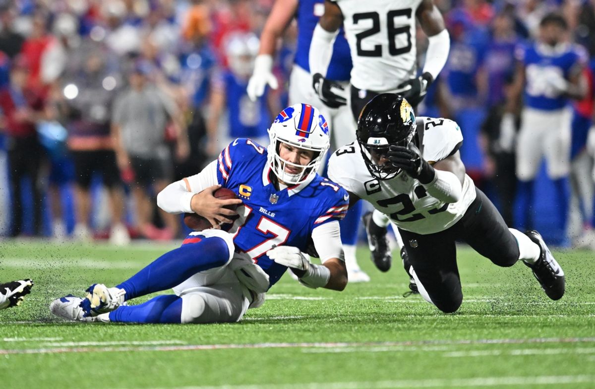 Sep 23, 2024; Orchard Park, New York, USA; Buffalo Bills quarterback Josh Allen (17) slides to avoid a tackle by Jacksonville Jaguars cornerback Tyson Campbell (32) in the second quarter at Highmark Stadium. Mandatory Credit: Mark Konezny-Imagn Images